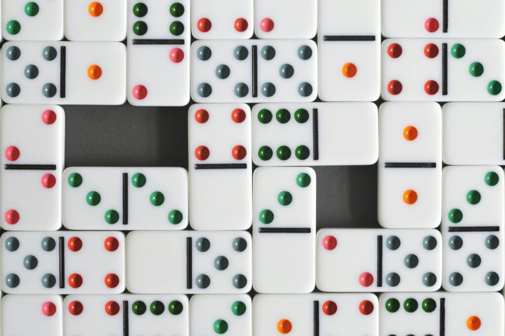 Close-up of dominoes arranged in a colorful pattern with a central gap, perfect for game-themed content.